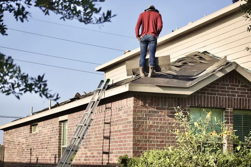 Professional roofer working on a residential roof in Clearview